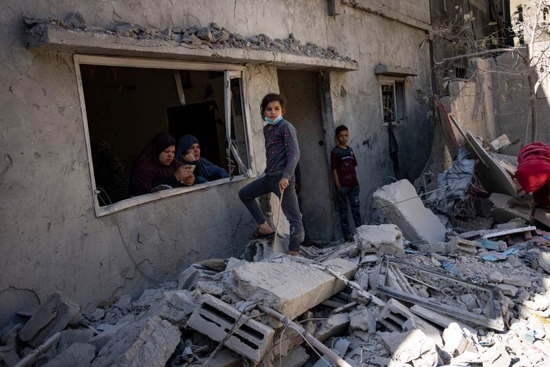 Members of the Abu Draz family inspect their house after it was hit by an Israeli airstrike in Rafah, southern Gaza Strip, Thursday, April 4, 2024. (AP Photo/Fatima Shbair)