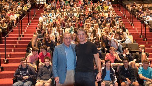 Tim Green (right) speaks to kids at Pace Academy in 2015. Falcons owner Arthur Blank (left) was on hand. (Photo special to the AJC)