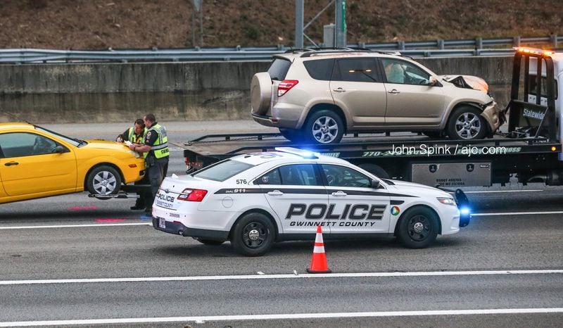 Gwinnett County police towed a gold SUV and a yellow car from the scene of a deadly pedestrian crash before reopening the southbound lanes of I-85 at Boggs Road. The crash investigation shut down the interstate for more than three hours Thursday morning.
