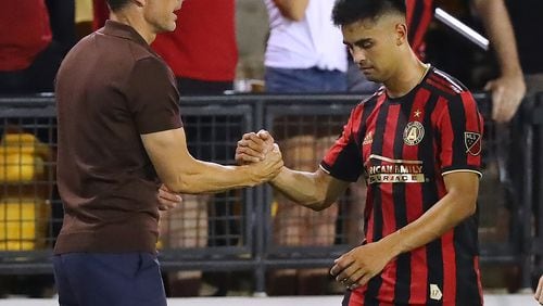 July 10, 2019 Kennesaw: Atlanta United midfielder Pity Martinez gets five from head coach Frank de Boer during a 2-0 victory over St. Louis in a U.S. Open Cup quarterfinals soccer match on Wednesday, July 10, 2019, in Kennesaw. Martinez scored Atlanta Unitedâs first goal in the game. Curtis Compton/ccompton@ajc.com