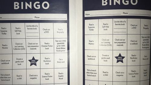 The bingo card on the left is the one originally distributed by the DeKalb County library system, and it included a prompt to “read a Christian fiction book.” After complaints, the library created new versions that says “Check out a cookbook.” (Tia Mitchell/tia.mitchell@ajc.com)