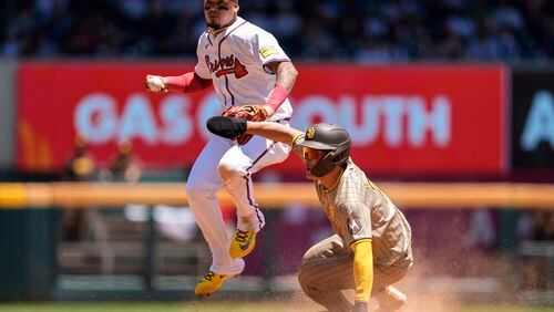 Atlanta Braves shortstop Orlando Arcia (11) throws the ball to first after San Diego Padres' Ha-Seong Kim (7) is out at second base in the sixth inning of a baseball game, Monday, May 20, 2024, in Atlanta. (AP Photo/Mike Stewart)
