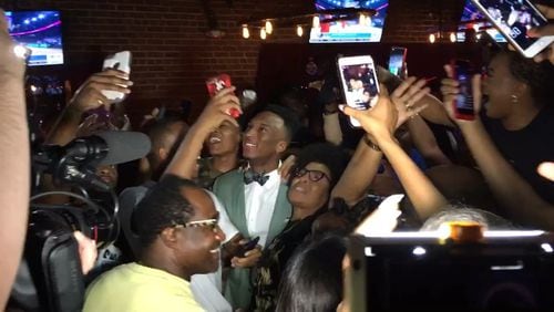 Former Georgia Tech guard Josh Okogie celebrates with family and friends Thursday night after he was selected in the first round of the NBA draft by the Minnesota Timberwolves. (Image captured from video)