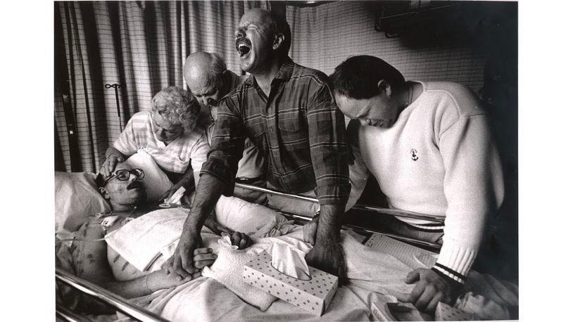 Moments before his death, Tom Fox is surrounded by grieving loved ones. At his side are his mother, Doris, his father, Bob Fox, Sr., his older brother, Bob Jr., and his younger brother, John, at Sacred Heart Hospital in Eugene, Oregon, on July 11, 1989.From a series of photographs titled "When AIDS Comes Home: The Life & Death of Tom Fox," by AJC photographer Michael Schwarz. The project was begun in early 1988 until the death of Tom Fox, an advertising account representative for the AJC, on July 11, 1989.MANDATORY CREDIT: MICHAEL SCHWARZ / THE ATLANTA JOURNAL-CONSTITUTION