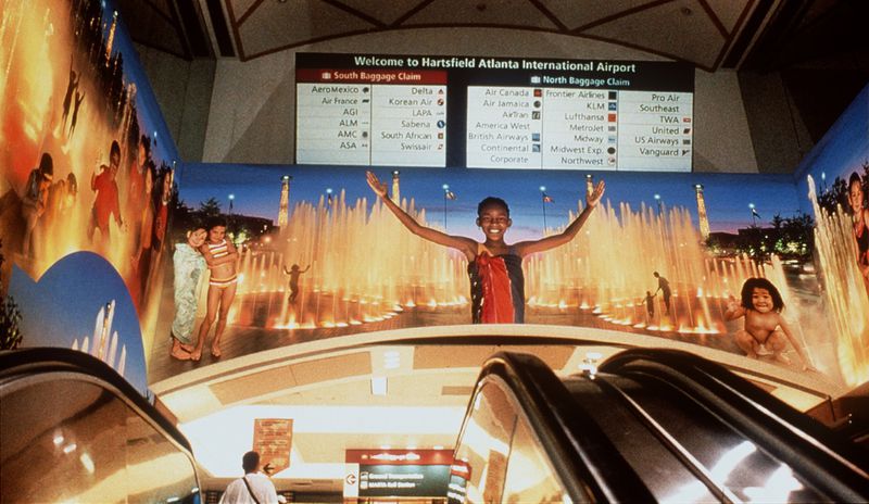 The “Spirit of Atlanta” photo mural measures 70 by 20 feet and greets travelers as they ride the escalator to the main terminal. (C) D. W. Whitehouse 2000.