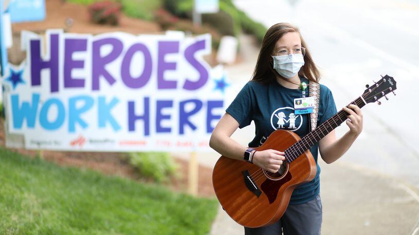 Music therapist Sarah McWaters poses outside the Children’s Healthcare in Atlanta. The coronavirus pandemic has altered how McWaters and other medical employees at the hospital do their job, despite the situation she has found the way to keep connected with her patients giving them music kits for them to ply at home. Friday, April 24, 2020. Miguel Martinez for the Atlanta Journal-Constitution
