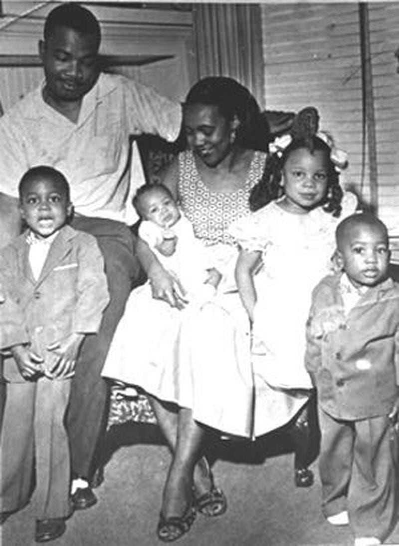 The (A.D.) King family. Gathered in the living room of their Auburn Avenue home in the early 1950s, Alveda King (girl in the white dress), leans on her mother, Naomi King. Her father, A.D. King, was the youngest brother of Martin Luther King Jr. He died in 1968.  Her baby sister Darlene is in her mother’s lap, flanked her brothers Alfred II and Derek.