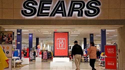 FILE - In this Wednesday, Feb. 8, 2017, file photo, shoppers walk into a Sears store in Pittsburgh. Sears Holdings Corp. on Thursday, March 9, 2017, reported a loss of $607 million in its fiscal fourth quarter. (AP Photo/Gene J. Puskar, File)