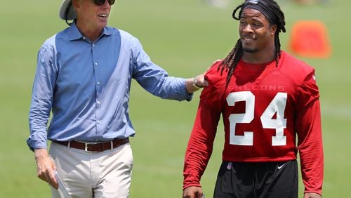Falcons President and CEO Rich McKay gives running back Devonta Freeman a pat  on the back.  Curtis Compton/ccompton@ajc.com