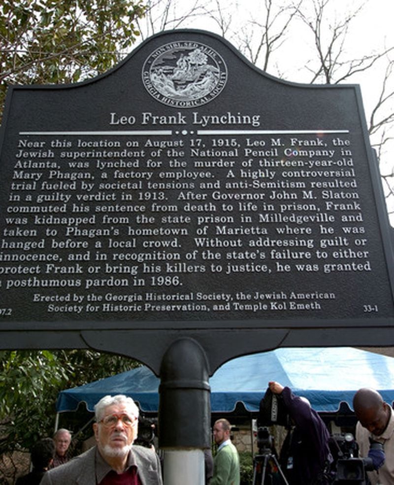 About 50 government, civic and religious leaders attended the unveiling of a Georgia Historical Society marker, placed near an I-75 bridge over Roswell Road at Frey's Gin, that tells the story of Leo Frank. (Andy Sharp/AJC)