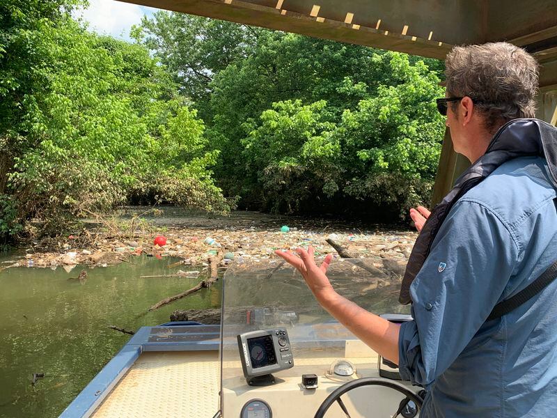 Trash that runs into the Chattahoochee River collects in some areas and have to be fished out. Jason Ulseth, the Chattahoochee Riverkeeper points out the mess. RODNEY HO/rho@ajc.com
