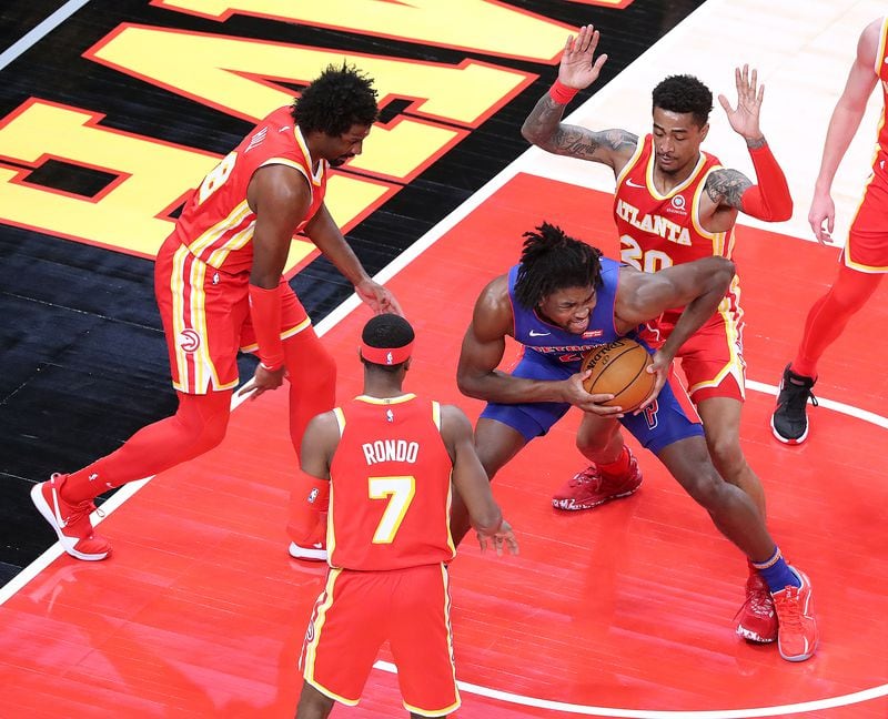 Hawks Solomon Hill (from left), Rajon Rondon and John Collins triple team Detroit Pistons Isaiah Stewart in the home opener Monday, Dec. 28, 2020, at State Farm Arena in Atlanta.  (Curtis Compton / Curtis.Compton@ajc.com)