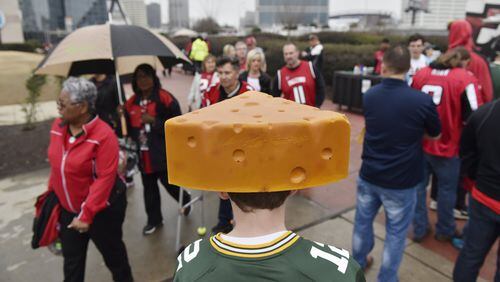 Packers fan Logan Coldren, 12, from Greenville, South Carolina, walks among Falcons fans before the start of the NFC Championship game against the Packers in Atlanta, Georgia, on Sunday, January 22, 2017. (DAVID BARNES / DAVID.BARNES@AJC.COM)