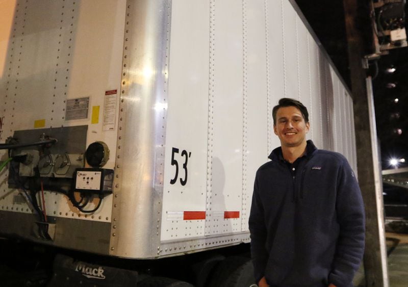 Clay Darity, an account manager for Atlanta Beverage, stands next to an 18-wheeler in Atlanta that is one of several around town filled with emergency alcohol in case a restaurant around town runs out during the weekend of the Super Bowl. EMILY HANEY / EMILY.HANEY@AJC.COM
