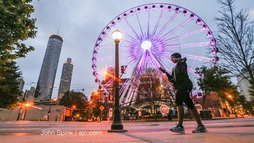 Kendra Reed gets in her 45-minute workout as she walks by SkyView Atlanta in downtown. JOHN SPINK / JSPINK@AJC.COM