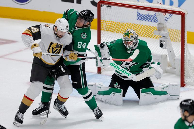 Dallas Stars goaltender Jake Oettinger, right, blocks a shot as teammate Roope Hintz (24) defends against Vegas Golden Knights center Tomas Hertl (48) during the first period in Game 7 of an NHL hockey Stanley Cup first-round playoff series, Sunday, May 5, 2024, in Dallas. (AP Photo/Brandon Wade)
