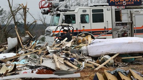 Rescue workers in a four wheeler pass by the remains of a home along Lee Road 38 after a F-3 tornado on Monday, March 4, 2019, in Beauregard, Alabama.Twenty-three people, including a six-year-old, were killed by a storm Sunday, though that number is expected to climb, Lee County Sheriff Jay Jones told reporters Monday morning. The destruction area is at least a half a mile wide and at least a mile long, he added.