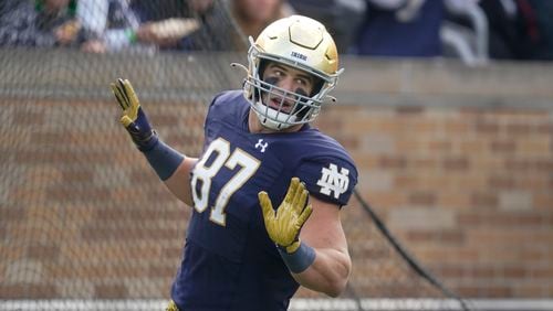 Notre Dame's Michael Mayer (87) reacts following a touchdown reception during the first half of an NCAA college football game against Georgia Tech, Saturday, Nov. 20, 2021, in South Bend, Ind. (AP Photo/Darron Cummings)