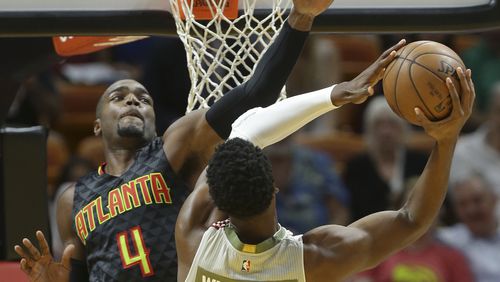 Miami Heat center Hassan Whiteside (21) goes to the basket as Atlanta Hawks forward Paul Millsap (4) defends during the first half of an NBA basketball game, Tuesday, Nov. 15, 2016, in Miami. (AP Photo/Lynne Sladky)
