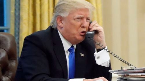 U.S. President Donald Trump speaks on the phone with Prime Minister of Australia Malcolm Turnbull in the Oval Office of the White House, Saturday, Jan. 28, 2017 in Washington. (AP Photo/Alex Brandon)