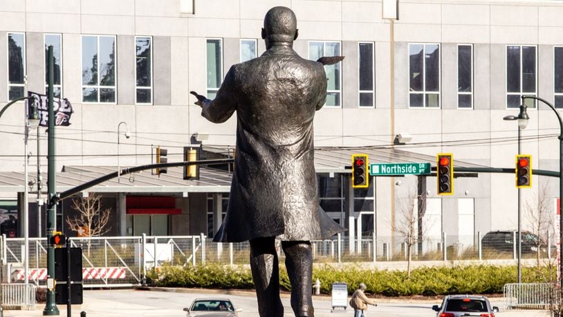 City of Atlanta unveils the bronze statue "Hope Moving Forward" honoring the life and legacy of Dr. Martin Luther King Jr. on Friday, January 15, 2021 near the intersection of Northside Drive and MLK Jr Drive.  This is the first of seven art installations commissioned by the city to honor MLK.  (Jenni Girtman for The Atlanta Journal Constitution)