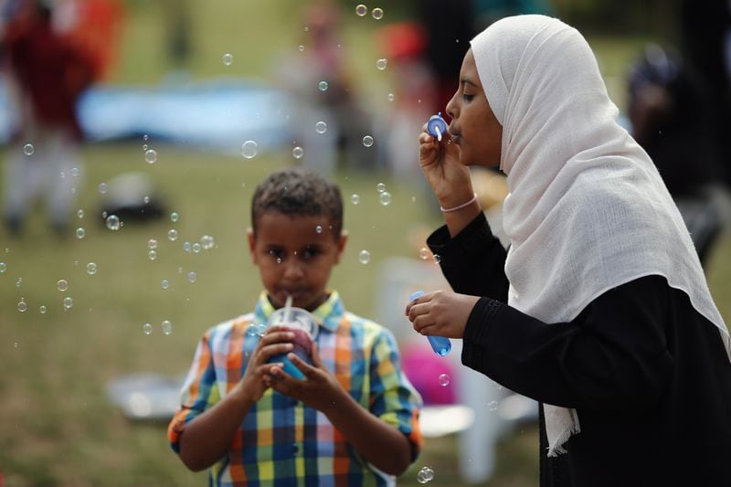 A girl blows bubbles during an Eid celebration in London, England.