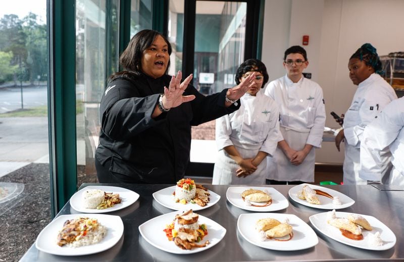 Chef Simone Byron, founder of the Navigate Program, talks to students after they prepare chef-driven meals. (Natrice Miller/AJC)