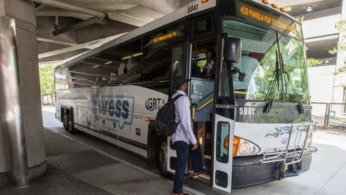 Passengers board a GRTA Xpress bus at the Dunwoody Marta Station, Monday, Aug. 10, 2015, in Dunwoody, Ga. BRANDEN CAMP/SPECIAL