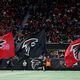 Falcons team members run with Falcons flags celebrating a touchdown during the second half against the New Orleans Saints at Mercedes-Benz Stadium, Sunday, January 9, 2022, in Atlanta. JASON GETZ// THE ATLANTA JOURNAL-CONSTITUTION