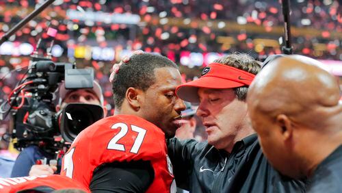 Georgia Bulldogs head coach Kirby Smart speaks to running back Nick Chubb (27) after the Bulldogs lost to the Alabama in the College Football Playoff National Championship at Mercedes-Benz stadium in Atlanta, Monday, Jan. 8, 2018.