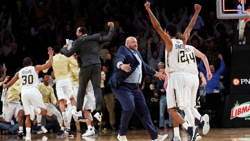 Georgia Tech players and coaches celebrate after defeating Notre Dame 62-60 in an NCAA college basketball game Saturday, Jan. 28, 2017, in Atlanta. (AP Photo/John Bazemore)
