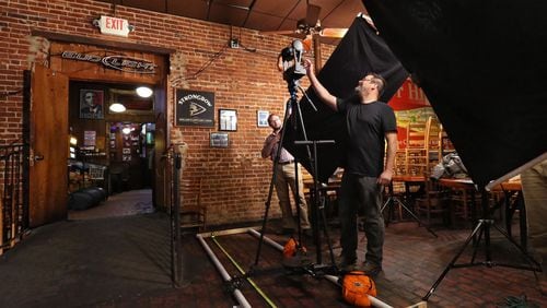 Michael Page, a lecturer at Emory University, prepares to photograph a wall at Manuel’s Tavern using the GigaPan system. Page, along with Ruth Dusseault of Georgia State University and other scholars and volunteers, are documenting the interior of Manuel’s Tavern before it goes through a major renovation. BOB ANDRES / BANDRES@AJC.COM