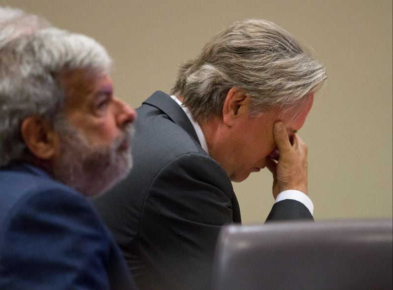 Former DeKalb County Police Officer Robert Olsen listens to testimony during his trial at the DeKalb County Superior Court  on Monday.  At left is his attorney Don Samuel. STEVE SCHAEFER / SPECIAL TO THE AJC