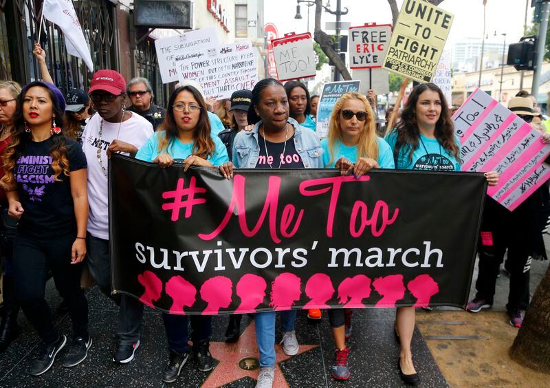 FILE - In this Nov. 1, 2017, file photo, Tarana Burke, founder and leader of the #MeToo movement, marches with others at the #MeToo March in the Hollywood section of Los Angeles. (AP Photo/Damian Dovarganes, File)