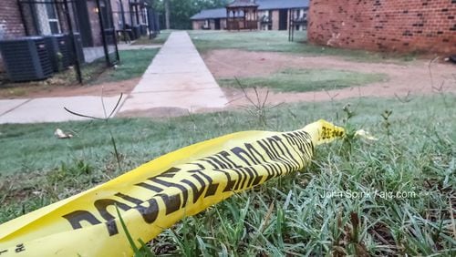 Crime scene tape remains at the site of a triple shooting investigation at an apartment complex in southwest Atlanta.