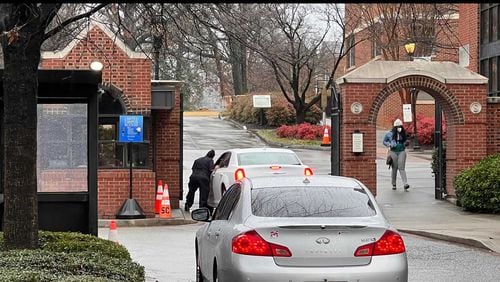 A Spelman College public safety officer stops a vehicle at the entrance to its campus on Thursday, Feb. 3, 2022. The college has received two bomb threats in recent weeks. (Eric Stirgus / Eric.Stirgus@ajc.com)