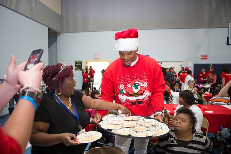 Cam Newton wore his Dabbin Santa sweater while sharing Christmas cheer. Photo: Cam Newton Foundation