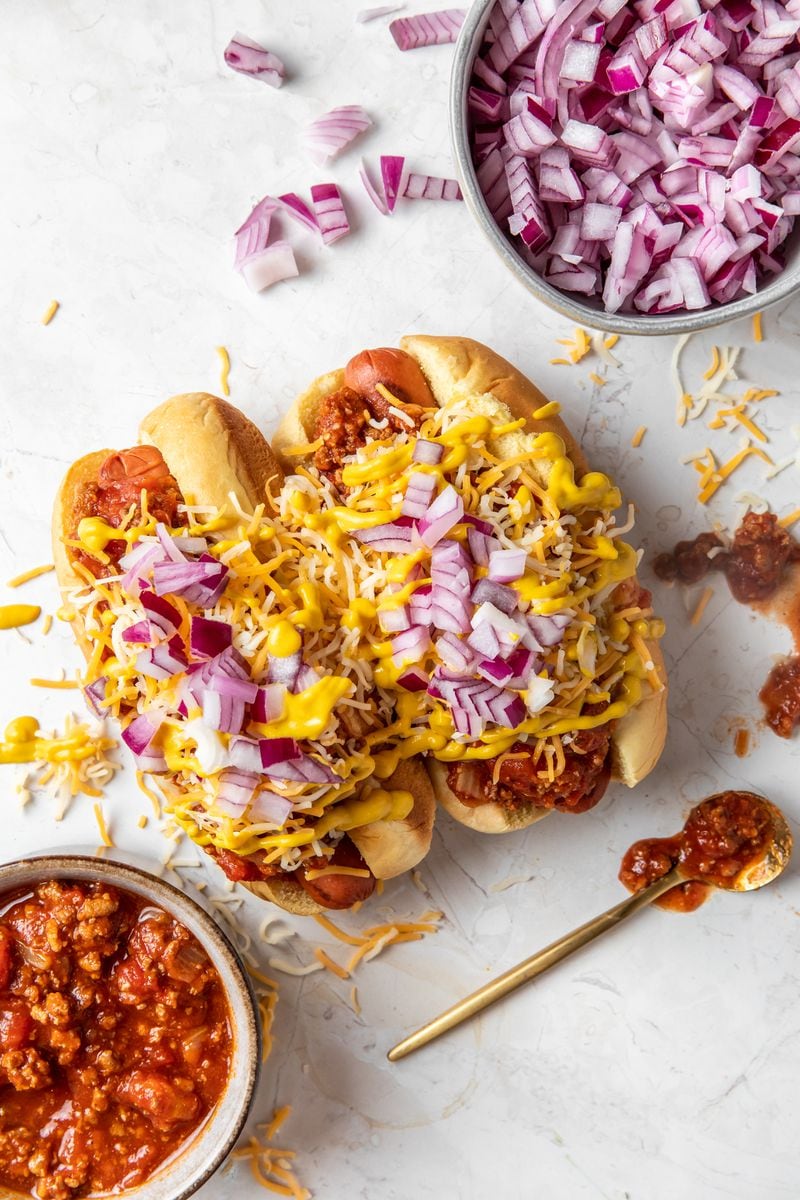 The Red Dawg from the menu of pop-up Pepper's Hot Dogs includes turkey chili, cheese, onions, garlic aioli and spicy mustard. /  Courtesy of @bitesandbevsmedia