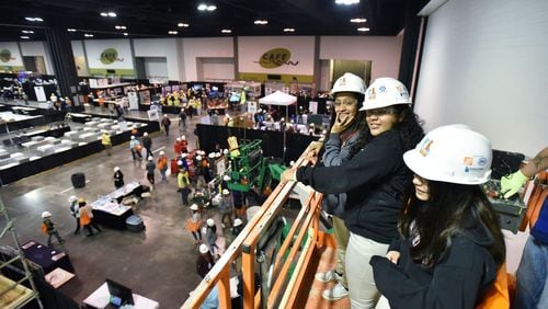 Students from Ridgeview Charter School in Sandy Springs ride on a scissor lift provided by McKenney’s Inc. during 2019 CEFGA CareerExpo at Georgia International Convention Center on March 21. Getting students career ready has taken on momentum in recent years — so much so that schools are starting as early as elementary school exposing kids to fields such as construction trades.