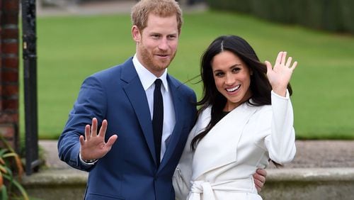 Newly engaged Prince Harry and Meghan Markle pose during a photo shoot at Kensington Palace. ASSOCIATED PRESS