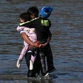 
                        A migrant family crosses the Rio Grande from Mexico in Eagle Pass, Texas, Jan. 3, 2024. More than 60 House Republicans traveled to the southern border in Texas on Wednesday, seeking to pressure the Biden administration to enact stricter immigration policies as a record number of migrants enter the U.S. (Kenny Holston/The New York Times)
                      