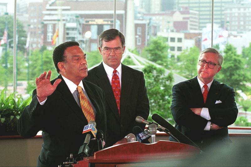 Atlanta Committee for the Olympic Games representatives Billy Payne (middle), A.D. Frazier (right), and Andrew Young (left), the trio mainly responsible for bringing the 1996 Summer Games to Atlanta, officially disband the organization July 1, 1999 in a ceremony overlooking Centennial Park (REAR). (DAVID TULIS/AJC Staff)