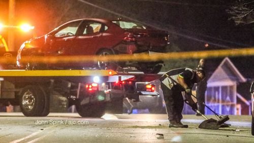 Crews clean up the scene after a driver lost control of a car and crashed into multiple parked cars east of McDaniel Street on Fulton Street, police said. The driver lost control  after being shot in the neck just before 2:40 a.m. Thursday.