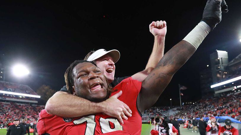 Georgia's Isaiah Wilson celebrates with head coach Kirby Smart after a 2019 win.