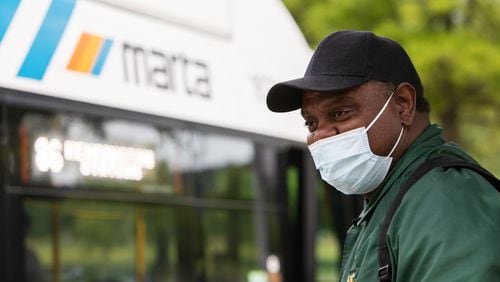 Jay Jackson waits at the MARTA bus stop near Stonecrest Mall on Tuesday. MARTA has announced that it will return to serving routes that were cut during the coronavirus pandemic. CHRISTINA MATACOTTA FOR THE ATLANTA JOURNAL-CONSTITUTION