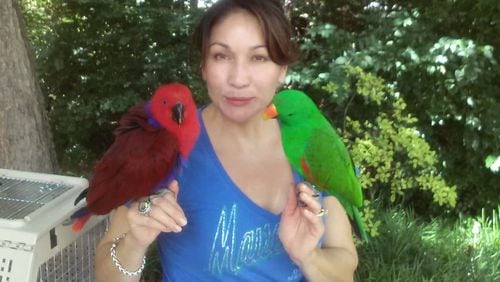 Frances Rodriguez with her two birds. Hoopidoopi (left) went missing last month.