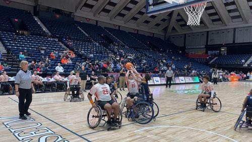 Houston County's Anthony Cuti (15) is defended by Clayton County's Edward Rhone (in blue) during Houston County's 35-16 victory in the wheelchair basketball state championship game at the Macon Coliseum on March 9, 2024.