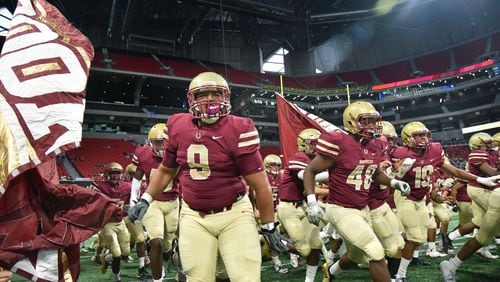Brookwood football players run onto the football field before the start of their game against North Gwinnett at the Corky Kell Classic Saturday, Aug. 18, 2018, at Mercedes-Benz Stadium in Atlanta.
