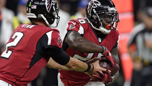 Atlanta Falcons quarterback Matt Ryan (2) hands off to running back Tevin Coleman (26) in the first half of an NFL football game in New Orleans, Monday, Sept. 26, 2016. (AP Photo/Bill Feig)
