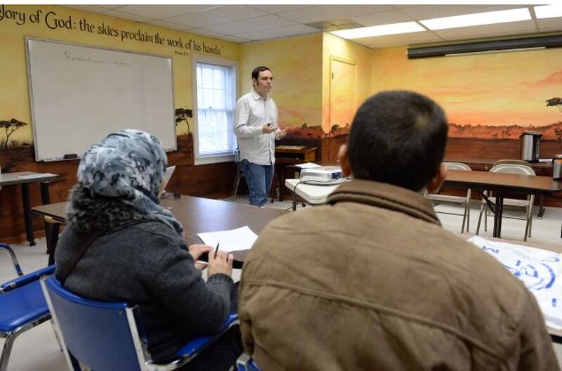 Syrian refugees Mohammad and his wife, Ebtesam listen to David Redd, senior case specialist, during an orientation session. KENT D. JOHNSON/ kdjohnson@ajc.com